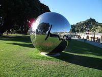 Large shiny sphere on the riverbank.